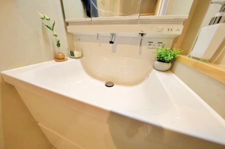 洗面台・洗面所　いつでもきれいに保ちたい空間のひとつ。鏡の裏や下の引き出しにしっかり収納できる三面鏡タイプの洗面化粧台をチョイス。