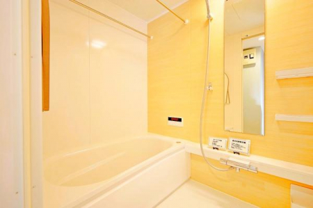 浴室　大きな縦長の鏡が特徴の温かい色味のバスルームは、湯船も広い！排水溝や換気口までもしっかりと手入れが行き届いています。
